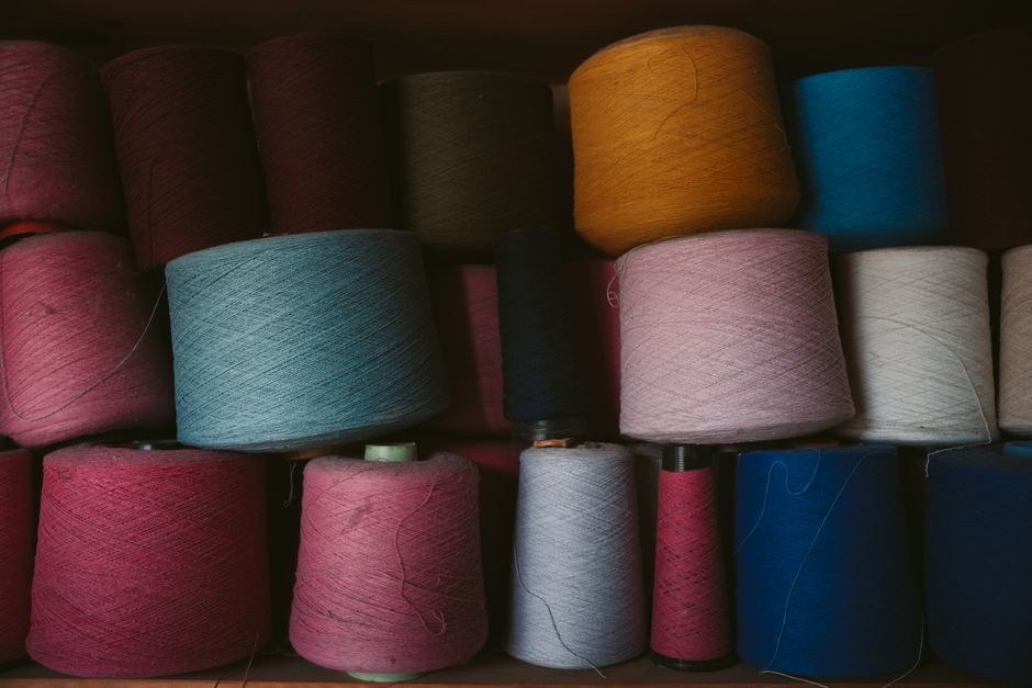 A vibrant display of yarn spools in Oaxaca, showcasing diverse colors and textures in a te